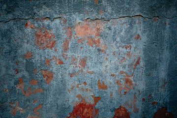 gray wall with red cracks on the plaster