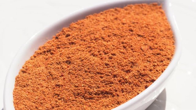 Dry spices paprika on a rotary table. 4K. Macroshooting.