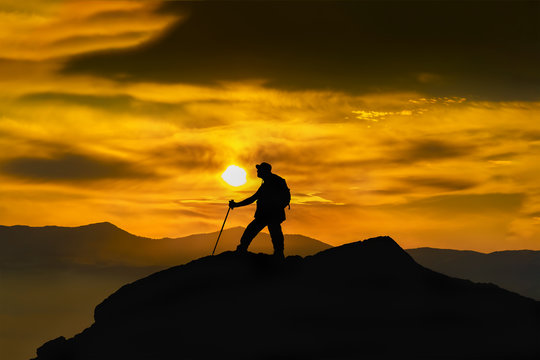 Silhouette of a rock climber on the peak. Sport and active life concept