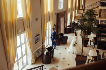 Beautiful Bride and Groom enjoy each other in the nice hall of the hotel. happy romantic young couple celebrating their marriage.Sexy kissing stylish couple of lovers close up portrait. wedding