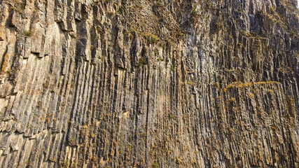 Obraz premium Rocky mountain with unique basalt pillars formed by volcanic lava, geology