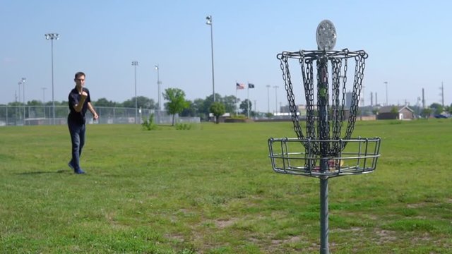 Male Disc Golfer Gets Lucky After Hitting The Chastity Belt Of The Basket - Disc Golf At A Public Park On A Clear Summer Day