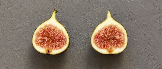 Half-cut fig on concrete background, view from above.