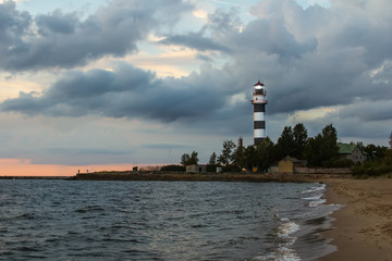 Naklejka premium Lighthouse at the entrance to the port of Riga in the evening, in August