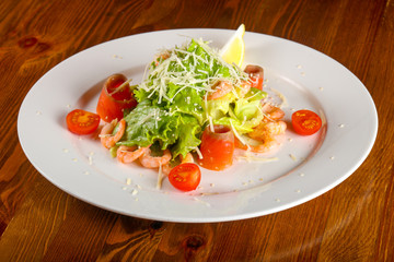 Caesar salad with shrimps and salmon
