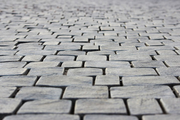 Old cobblestone pavement of square stones near the Sugarloaf Mountain. Republic of Crimea. Abstract background