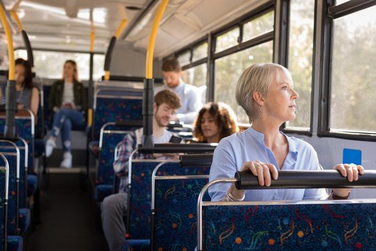 Female commuter looking through window while travelling in bus