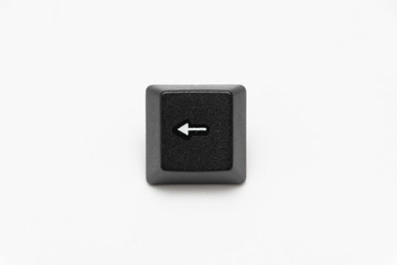 Single black keys of keyboard with different letters left arrow