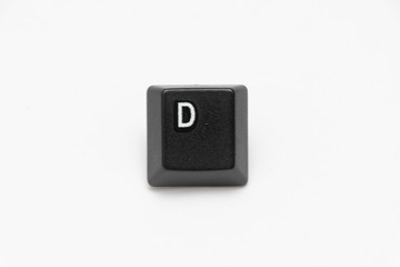 Single black keys of keyboard with different letters D