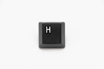 Single black keys of keyboard with different letters H