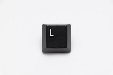Single black keys of keyboard with different letters L