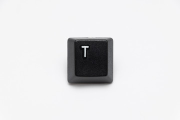Single black keys of keyboard with different letters T