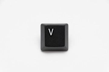 Single black keys of keyboard with different letters V