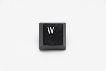 Single black keys of keyboard with different letters W