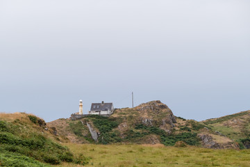 Fototapeta na wymiar Leuchtturm mit Haus Baltimore Irland Lighthouse and house Ireland