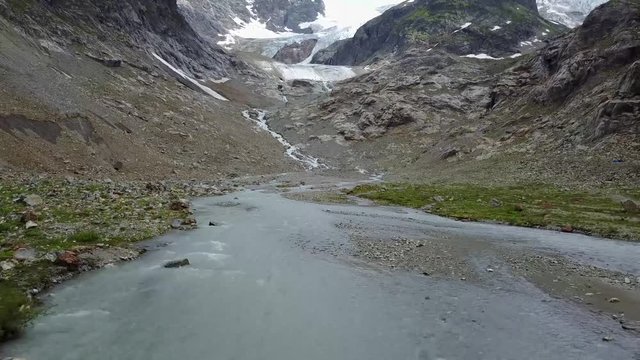 Flyover a small mountain stream in the Swiss Alps.