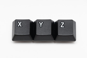 Single black keys of keyboard with different letters XYZ