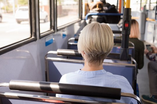 Woman travelling in modern bus