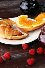 croissants with marmalade and assortment of jams, seasonal berries, apricot, mint and fruits