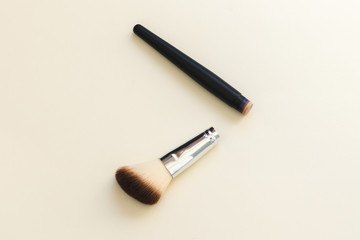 Broken cosmetic brush on a light background