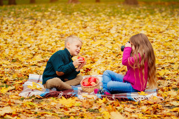 children playing in the nature , boy photographs , young children in autumn Park
