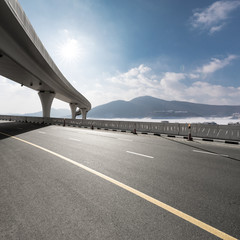 highway through mountain with blue sky