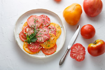 Tomato sliced on a plate. Top view