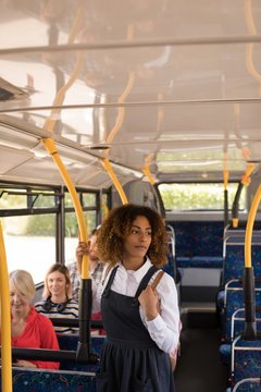 Female commuter travelling in modern bus