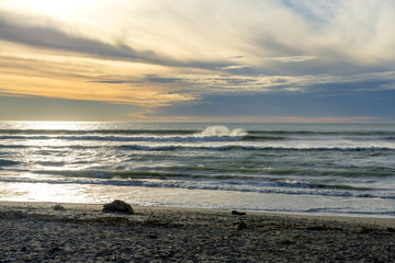 Waves catching the sunlight as sunsets over Hokitika