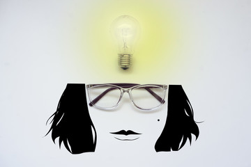 Glasses and a light bulb with a cartoon face