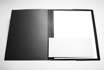 Folder, blank sheets of paper, and envelope