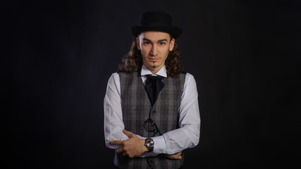 The handsome caucasian young man in a white shirt, suit and hat
