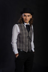 The handsome caucasian young man in a white shirt, suit and hat