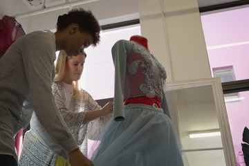 Fashion designers dressing mannequin