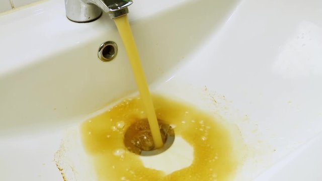 Close up dirty water flowing in sink