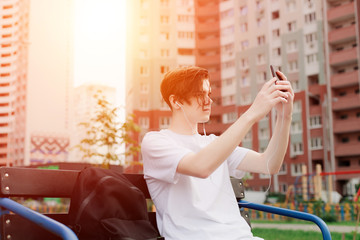 Young man taking picture outdoor. Urban style