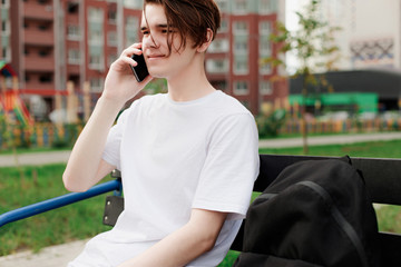 Guy sitting and listens by the phone