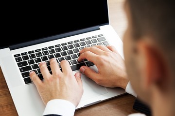 Closeup of a Businessman Typing on a Laptop