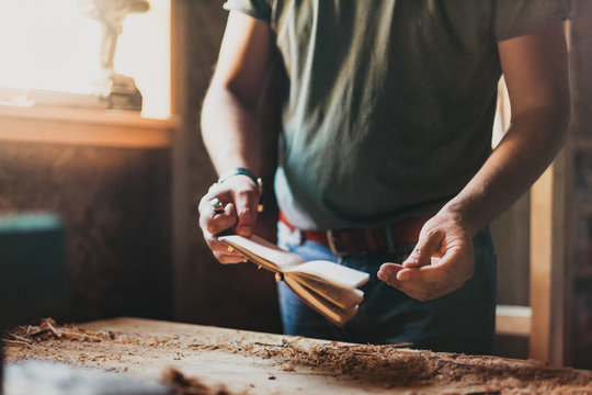Writer taking notes in his cabin - Powered by Adobe