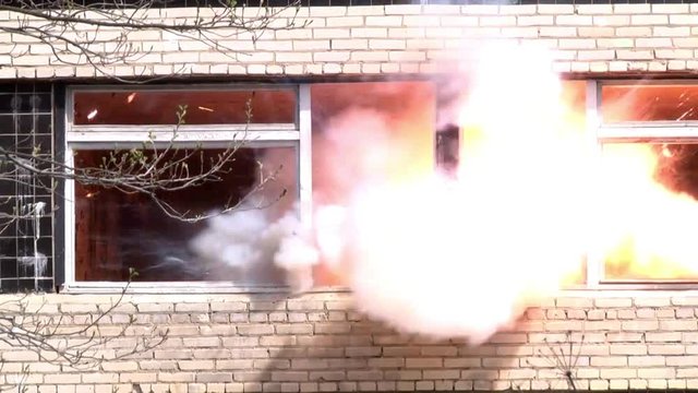 Military hand grenade explosion on background of destroyed house. Impact strength and power of airsoft guns.