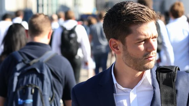 Businessman With Takeaway Drink Walking To Work In Slow Motion