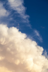 View of cumulonimbus thunderstorm cloud and cirrus cloud with blue sky in the background