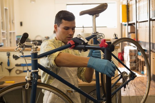 Man mounting bicycle on repair stand