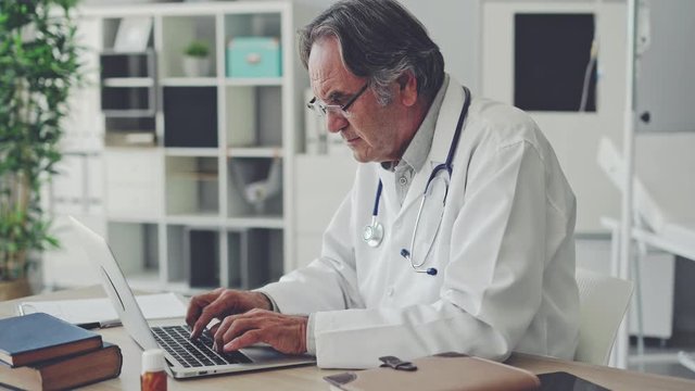 Doctor working with laptop computer