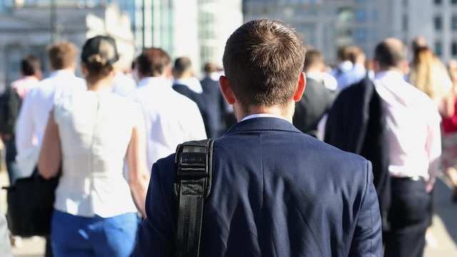 Rear View Of Businessman Walking To Work In Slow Motion