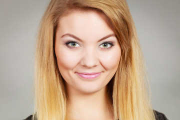Naklejka premium Portrait of happy blonde woman smiling with joy