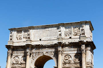Fototapeta na wymiar Top of the Arch of Constantine, Rome, Italy, with a bright blue sky background