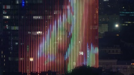 Office skyscraper facade with innovation illumination at night - Powered by Adobe