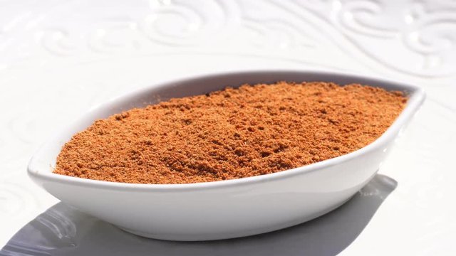 Dry spices paprika on a rotary table. 4K. Macroshooting.