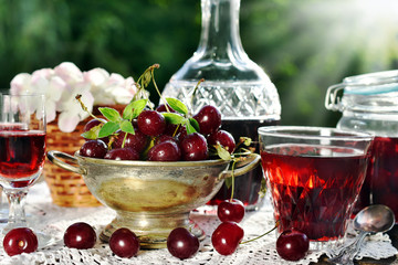 cherry liqueur in crystal carafe and fresh fruits
